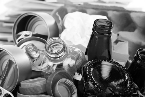 Waste collection vehicle parked outside a commercial property with staff preparing equipment