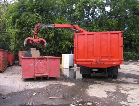 Workers preparing a man-and-van removal outside a suburban terraced house in Cheshunt